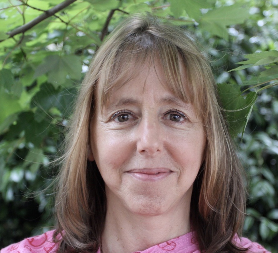 A close up of a person in a pink shirt

Description automatically generated