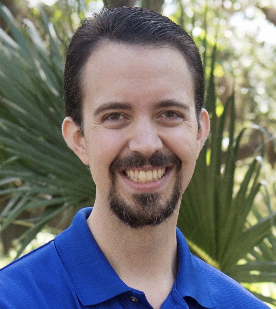 A person wearing a blue shirt and smiling at the camera

Description automatically generated
